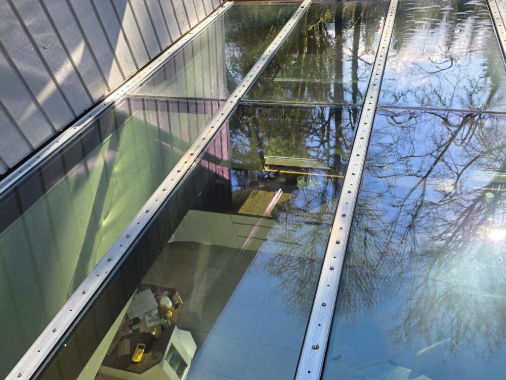 Clean glass awning reflecting trees after professional window washing in Vancouver, BC.